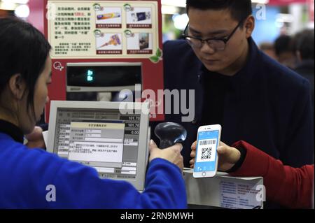 (151212) -- HANGZHOU, Dec. 12, 2015 -- A customer scans QR code to pay with Alipay at a supermarket in Hangzhou, capital of east China s Zhejiang Province, Dec. 12, 2015. China s largest online payment platform Alipay and Koubei.com, both belongs to Alibaba Group, joined hands to promote an offline sales promotion, in which customers are entitled to enjoy discount with payment by Alipay. More than 300,000 offline merchants at home and abroad took part in the event. ) (lfj) CHINA-ALIBABA-OFFLINE PROMOTION (CN) JuxHuanzong PUBLICATIONxNOTxINxCHN   151212 Hangzhou DEC 12 2015 a Customer Scans QR Stock Photo