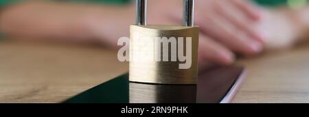 Closed metal padlock on modern smartphone, personal data protection Stock Photo