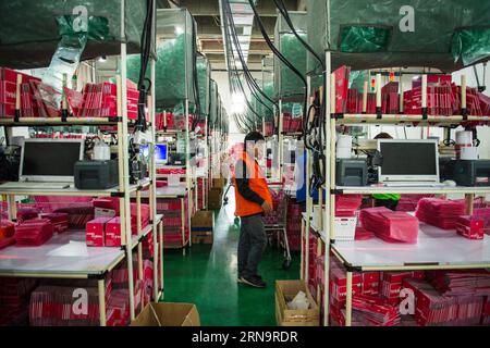 File photo taken on Feb. 28, 2015 shows a worker checking parcels of goods at a storehouse in Qianhaiwan bonded port zone in Shenzhen, south China s Guangdong Province. About 100,000 e-commerce parcels of foreign goods bought by Chinese online shoppers arrived at the bonded port zone everyday. As host of the Second World Internet Conference (WIC) that is underway in Wuzhen in east China s Zhejiang Province, China called for global Internet interconnectivity and shared governance by all. As one of the greatest inventions of the 20th century, the Internet has turned the globe into a village and Stock Photo