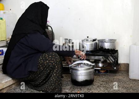 A Yemeni woman cooks inside a temporary evacuation center in Sanaa, capital of Yemen, Dec. 19, 2015, as her family was forced to flee from home due to the ongoing air strikes and internal conflicts. According to the United Nations High Commissioner for Refugees (UNHCR), there are 2.5 million internal displaced persons (IDPs) as a result of the nine-month civil war in Yemen. Hani Ali) YEMEN-SANAA-DISPLACED PEOPLE MohammedxMohammed PUBLICATIONxNOTxINxCHN   a Yemeni Woman Cooks Inside a temporary Evacuation Center in Sanaa Capital of Yemen DEC 19 2015 As her Family what Forced to Flee from Home D Stock Photo
