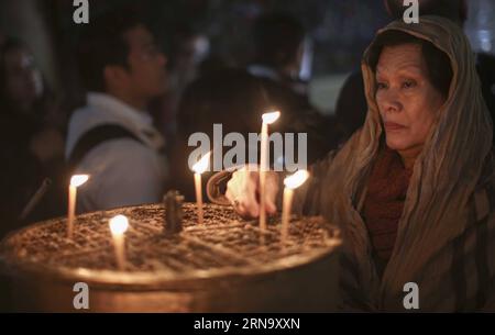 Betlehem: Christliche Pilger beten in der Geburtskirche (151224) -- BETHLEHEM, Dec. 24, 2015 -- A Christian worshiper lights candles in the Church of the Nativity, in the West Bank city of Bethlehem, Dec. 24, 2415. Christian pilgrims are preparing to gather in the traditional birthplace of Jesus Christ in the West Bank to celebrate Christmas. ) MIDEAST-BETHLEHEM-CHURCH-OF-THE-NATIVITY FadixArouri PUBLICATIONxNOTxINxCHN   Bethlehem Christian Pilgrims pray in the Church of the Nativity 151224 Bethlehem DEC 24 2015 a Christian worshiper Lights Candles in The Church of The Nativity in The WEST Ban Stock Photo