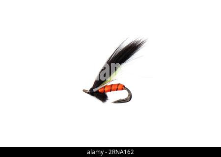 Macro shot colorful fishing fly isolated on a white background. Hand made fly fishing flies. Fluffy fly fishing hook isolated. Stock Photo