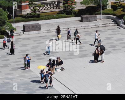 TOKYO, JAPAN - July 16, 2023: People in front of Tokyo Station on a hot day. Stock Photo