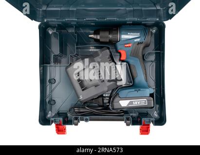 Cordless battery screwdriver drill in plstix case isolated on white background. lithium-ion battery and charging station. Lithium rechargeable battery Stock Photo