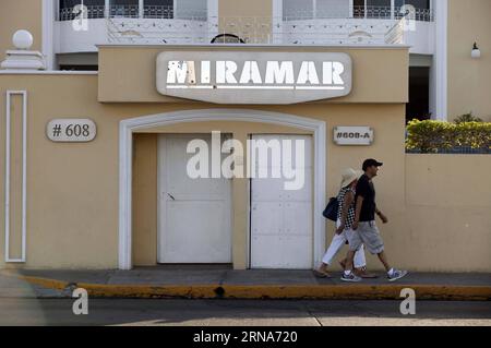 (160109) -- MAZATLAN, Jan 9, 2016 -- File photo taken on July 12, 2015 shows people walking past the Miramar condominium, the site where Mexico s drug cartel kingpin Joaquin Guzman Loera was arrested during his previous escape from prison on Feb. 22, 2014, in the city of Mazatlan, Sinaloa, Mexico. After an early morning raid in northwestern Mexico s Sinaloa State s town of Los Mochis by Mexican police and marines on Friday, Sinaloa Cartel leader Joaquin El Chapo Guzman Loera was recaptured, six months after his second prison break. In 2001, Guzman was wheeled out by a janitor in a laundry cart Stock Photo