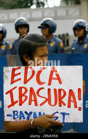 Protest vor US-Botschaft in Manila (160114) -- MANILA, Jan. 14, 2016 -- An activist holds a placard during a protest rally in front of the U.S. Embassy in Manila, the Philippines, Jan. 14, 2016. The activists are calling for an end to the Enhanced Defense Cooperation Agreement (EDCA) after the Philippine Supreme Court decided that the Philippines defense cooperation deal with the United States is constitutional and does not need the concurrence of the Senate. ) (zjy) PHILIPPINES-MANILA-ANTI-EDCA-PROTEST RouellexUmali PUBLICATIONxNOTxINxCHN   Protest before U.S. Embassy in Manila 160114 Manila Stock Photo