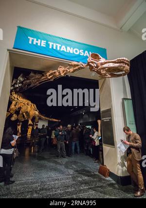 (160114) -- NEW YORK, Jan. 14, 2016 -- People visit the Titanosaur skeleton exibition in the American Museum of Natural History in New York, the United States, Jan. 14, 2016. Starting from Jan. 15, the American Museum of Natural History will add another must-see exhibit -- a cast of a 122 foot (37.2m) dinosaur. The dinosaur has not yet been formally named by scientists who discovered it, but was inferred by paleontologists that it was a giant herbivore that belongs to a group known as titanosaurs weighing as much as 70 tons. The cast is based on 84 fossil bones that were excavated in Argentine Stock Photo
