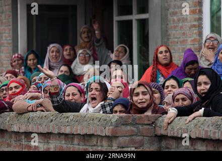 (160114) -- SRINAGAR, Jan. 14, 2016 -- Kashmiri women wail over the death of Owais Bashir Malik, an engineering student, during his funeral procession in Srinagar, summer capital of Indian-controlled Kashmir, Jan. 14, 2016. Indian police fired warning shots and tear gas shells to disperse hundreds of Kashmiri protesters who had blocked road to Srinagar airport and shouting anti-India slogans after the body of a college student with his throat slit was found in the Indian-controlled Kashmir. The protesters accused the Indian army of torturing and killing the student. However, the army denied th Stock Photo