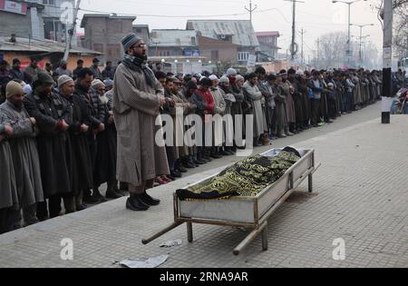 (160114) -- SRINAGAR, Jan. 14, 2016 -- Kashmiri people offer funeral prayers for Owais Bashir Malik, an engineering student, during his funeral procession in Srinagar, summer capital of Indian-controlled Kashmir, Jan. 14, 2016. Indian police fired warning shots and tear gas shells to disperse hundreds of Kashmiri protesters who had blocked road to Srinagar airport and shouting anti-India slogans after the body of a college student with his throat slit was found in the Indian-controlled Kashmir. The protesters accused the Indian army of torturing and killing the student. However, the army denie Stock Photo