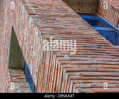 The Angled view on modern red clinker brick facade wall of residential building house Stock Photo