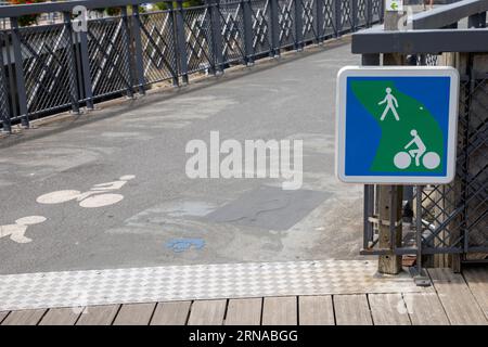 blue green sign pedestrian route and bike path road with pathway Stock Photo