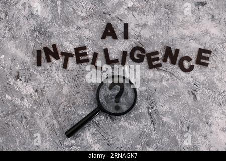 AI intelligence text with magnifying glass analysing a question mark, is machine learning really intelligent? Stock Photo