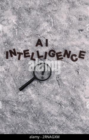 AI intelligence text with magnifying glass analysing a question mark, is machine learning really intelligent? Stock Photo
