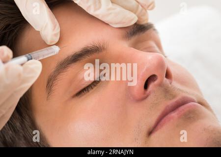 Young Man Having Face Lifting Treatment At Beauty Clinic Stock Photo