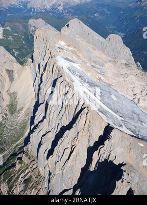 AERIAL VIEW. Summit of Marmolada (3343m) with the southern cliff (in Veneto) and the northern glaciers (in Trentino-Alto Adige). Dolomites, Italy. Stock Photo