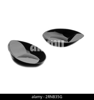 Two black plastic dessert plates isolated over white background, confectionery object photography, clipart wallpaper Stock Photo