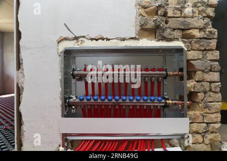 Main control manifold of house heating system, work in progress on construction site for a flat residence building Stock Photo
