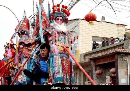 A folk artist takes a break at a temple fair in Junxian County, central China s Henan Province, Feb. 23, 2016. The traditional temple fair, with a history of over 1,600 years, reached its peak on the first day after the Lantern Festival as showing folk performing arts such as dragon dance, lion dance, stilt performance, land boat and so on. ) (cxy) CHINA-HENAN-JUNXIAN-TEMPLE FAIR (CN) LixAn PUBLICATIONxNOTxINxCHN   a Folk Artist Takes a Break AT a Temple Fair in Junxian County Central China S Henan Province Feb 23 2016 The Traditional Temple Fair With a History of Over 1 600 Years reached its Stock Photo