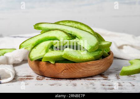 Natural dried pomelo slices in bowl on wooden background. Fruit snack for a health diet and alternative desert. Close up Stock Photo