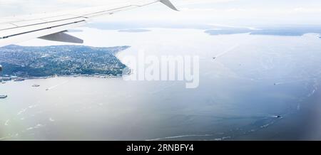 Aerial view of an airplane wing flying towards Seattle. Washington. Stock Photo