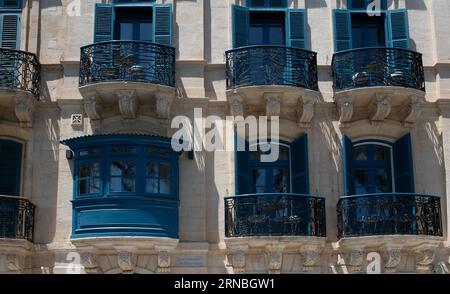 Detail of the facade of the historic Vincenzo Buceia Conservatory in Malta. You can see the typical blue balconies Stock Photo