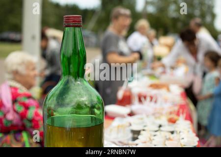 large antique glass bottle with light green liquid as medicine and