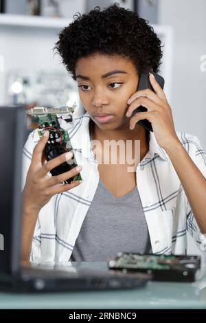 female engineer or tech repairs electronic Stock Photo