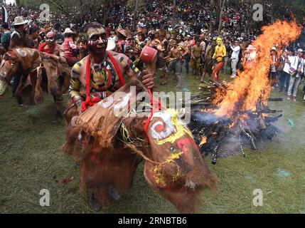 (160311) -- MILE, March 11, 2016 -- Men of Yi ethnic group ride dummy horses beside a bonfire during the annual fire worshipping festival, which falls on the third day of the second month in the Chinese lunar calendar at Xiyi Township under Mile City, southwest China s Yunnan Province, March 11, 2016. ) CHINA-YUNNAN-YI ETHNIC GROUP-FIRE WORSHIPPING FESTIVAL(CN) LinxYiguang PUBLICATIONxNOTxINxCHN   Mile March 11 2016 Men of Yi Ethnic Group Ride Dummy Horses Beside a Bonfire during The Annual Fire Worshiping Festival Which Falls ON The Third Day of The Second Month in The Chinese Lunar Calendar Stock Photo
