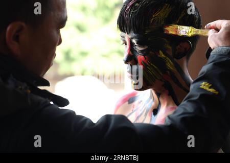 (160311) -- MILE, March 11, 2016 -- A young man get himself painted in preparation for local Yi people s annual fire worshipping festival, which falls on the third day of the second month in the Chinese lunar calendar at Xiyi Township under Mile City, southwest China s Yunnan Province, March 11, 2016. ) (yxb) CHINA-YUNNAN-YI ETHNIC GROUP-FIRE WORSHIPPING FESTIVAL(CN) LinxYiguang PUBLICATIONxNOTxINxCHN   Mile March 11 2016 a Young Man Get himself Painted in Preparation for Local Yi Celebrities S Annual Fire Worshiping Festival Which Falls ON The Third Day of The Second Month in The Chinese Luna Stock Photo