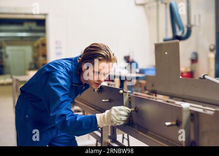 Concentrated worker fixing metal construction Stock Photo