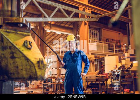 Smiling man working on factory Stock Photo