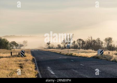 Low-hanging mist over the Larapinta Drive between Alice Springs (Mparntwe) and Simpsons Gap (Rungutjirpa) in the Northern Territory of Australia Stock Photo