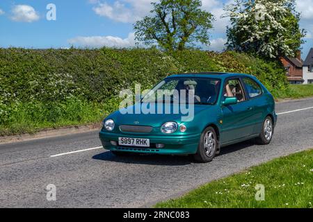 1998 90s nineties Toyota Corolla Cd Auto Green Car Hatchback Petrol 1332 cc en-route to Capesthorne Hall classic car show, Cheshire, UK Stock Photo