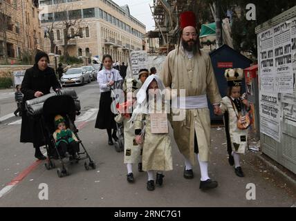(160326) -- JERUSALEM, March 26, 2016 -- An Ultra-Orthodox Jewish family walk in a street during celebrations for the Purim Festival in Jerusalem s Mea Shearim neighbourhood, on March 25, 2016. Purim is a celebration of the Jews salvation from genocide in ancient Persia, as recounted in the Book of Esther. ) MIDEAST-JERUSALEM-PURIM FESTIVAL-CELEBRATIONS GilxCohenxMagen PUBLICATIONxNOTxINxCHN   Jerusalem March 26 2016 to Ultra Orthodox Jewish Family Walk in a Street during celebrations for The Purim Festival in Jerusalem S MEA Shearim Neighbourhood ON March 25 2016 Purim IS a Celebration of The Stock Photo