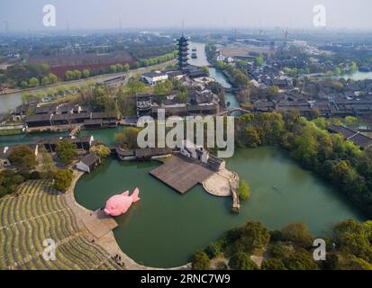 (160327) -- TONGXIANG, Marcj 27, 2016 -- Photo taken on March 27, 2016 shows a giant pink Floating Fish on the water theatre in Wuzhen, east China s Zhejiang Province. The pink Floating Fish is a piece of works designed by Florentijn Hofman, who is also know for creating a huge Rubber Duck in Hong Kong in 2013, for the Wuzhen International Contemporary Art Exhibition. The Floating Fish is made of floating plates for swimming. The exhibition will be held here from March 28 to June 26. ) (lfj) CHINA-ZHEJIANG-WUZHEN- FLOATING FISH (CN) XuxYu PUBLICATIONxNOTxINxCHN   Tong Xiang Marcj 27 2016 Photo Stock Photo