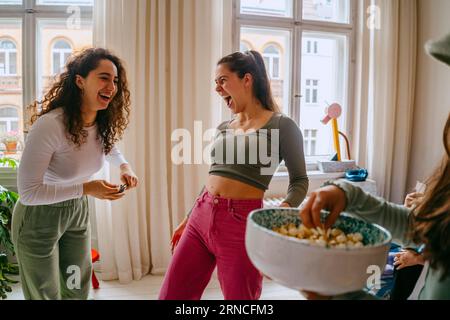 Playful young women enjoying weekend together at home Stock Photo