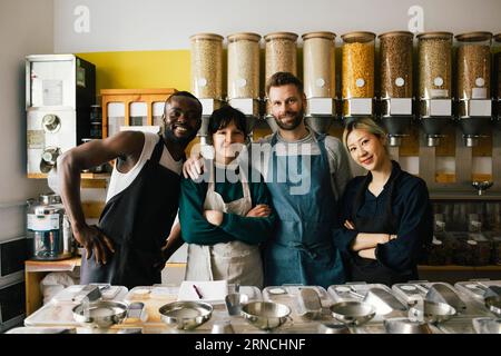 Portrait of smiling male and female multiracial colleagues in food store Stock Photo