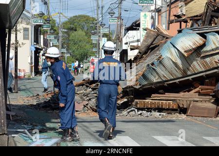 (160417) -- KUMAMOTO, April 17, 2016 -- Firefighters check the buildings in the earthquake rocked Mashiki in Kumamoto prefecture, Japan, April 17, 2016. A powerful magnitude-7.3 earthquake struck the island of Kyushu in southwestern Japan early Saturday just a day after a sizable foreshock hit the region, with the number of fatalities now standing at 41 according to the latest figures on Sunday. ) (djj) JAPAN-KUMAMOTO-EARTHQUAKE-AFTERMATH MaxPing PUBLICATIONxNOTxINxCHN   160417 Kumamoto April 17 2016 Firefighters Check The Buildings in The Earthquake Rocked Mashiki in Kumamoto Prefecture Japan Stock Photo