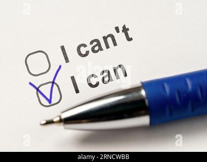 success and motivate message.Choice I can in checkbox. I can choose or I can't options and pen on white paper background. Stock Photo