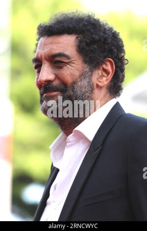 VENICE, ITALY - AUGUST 31: Ramzy Bedia, Xavier Giannoli, Olga Kurylenko