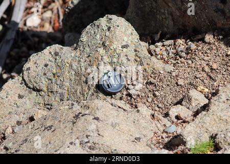 Canon Lens cap lost on the side of mountain . High quality photo Stock Photo