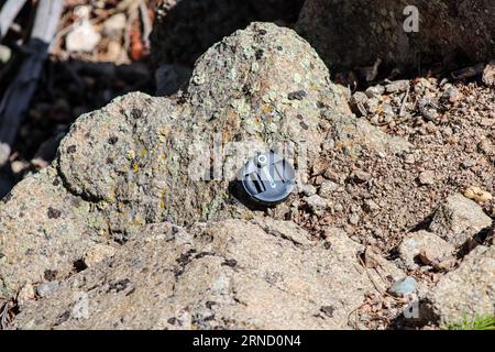 Canon Lens cap lost on the side of mountain . High quality photo Stock Photo