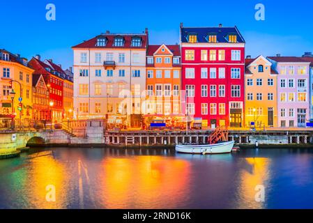 Charm of Copenhagen, Denmark at Nyhavn. Iconic canal, colorful night image and breathtaking water reflections. Stock Photo