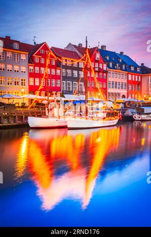 Copenhagen, Denmark. Charm of Nyhavn iconic canal. Colorful night image and breathtaking water reflections. Stock Photo