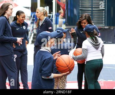 NEW YORK, April 27, 2016 -- U.S. First Lady Michelle Obama (back, 1st R) takes part in the basketball demonstration during the Team USA s Road to Rio Tour activity at Times Square in New York, the United States on April 27, 2016. Team USA s Road to Rio Tour was held at Times Square on Wednesday to mark the 100-Day countdown to the 2016 Olympic Games in Rio de Janeiro. More than 70 Olympic and Paralympic athletes participated in the event and shared their spirit and excitement of the Games with fans here. ) U.S.-NEW YORK-OLYMPIC GAMES-100 DAYS-COUNTDOWN QinxLang PUBLICATIONxNOTxINxCHN   New Yor Stock Photo