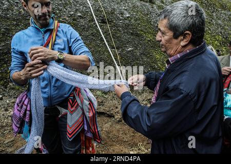 (160502) -- METEORA(GREECE), May 2, 2016 -- A climber ties up scarves around his waist before climbing up the cliff behind the church of St. George Mandilas, which means scarf in Greek, in Kastraki village at Meteora in central Greece on May 2, 2016. Following a 300-year custom each year during the celebrations of Saint George s name day, climbers leave scarves in a cave 40 meters above the village on the sandstone rocks and return with old ones and give them away to people for a sign of good luck. ) GREECE-METEORA-SAINT GEORGE-CELEBRATION LefterisxPartsalis PUBLICATIONxNOTxINxCHN   160502 Met Stock Photo