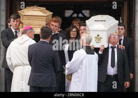 Paul McSweeney (right) carries the coffins of his children Luke, 24 and Grace McSweeney, 18, as they are blessed following their funeral at Saints Peter and Paul's Church, Clonmel, Co Tipperary. Picture date: Friday September 1, 2023. Stock Photo