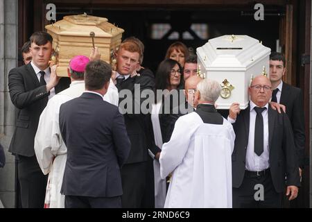 Paul McSweeney (right) carries the coffins of his children Luke, 24 and Grace McSweeney, 18, as they are blessed following their funeral at Saints Peter and Paul's Church, Clonmel, Co Tipperary. Picture date: Friday September 1, 2023. Stock Photo