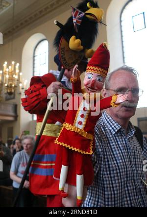 (160508) -- LONDON, May 8, 2016 -- A professor holding a puppet enters into St Paul s Church for a special church service in London, Britain on May 8, 2016. Mr. Punch made his first recorded appearance in England on 9 May 1662, which is traditionally reckoned as Punch s UK birthday. The diarist Samuel Pepys observed a marionette show featuring an early version of the Punch character in Covent Garden in London. ) BRITAIN-LONDON-THE PUNCH AND JUDY SHOW HanxYan PUBLICATIONxNOTxINxCHN   160508 London May 8 2016 a Professor Holding a Puppet enters into St Paul S Church for a Special Church Service Stock Photo