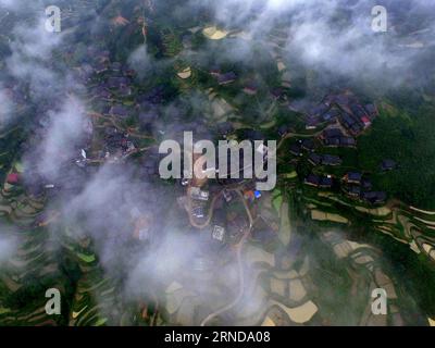 (160512) -- SANJIANG, May 12, 2016 -- This photo taken with unmanned aerial vehicle on May 8, 2016 shows the Guishu Village in Sanjiang Dong Autonomous County, south China s Guangxi Zhuang Autonomous Region. Sanjiang Dong Autonomous County, located in the north of Guangxi, is renowned in the world for its large numbers of drum towers, wind and rain bridges and traditional buildings of Dong ethnic group. ) (zwx) CHINA-GUANGXI-SANJIANG-SCENERY (CN) HuangxXiaobang PUBLICATIONxNOTxINxCHN   Sanjiang May 12 2016 This Photo Taken With Unmanned Aerial Vehicle ON May 8 2016 Shows The  Village in Sanjia Stock Photo